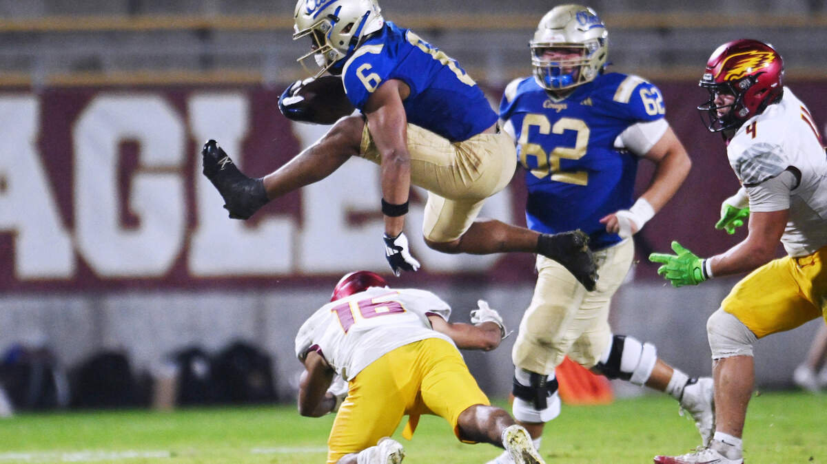 Clovis High’s James Curoso, top, hurdles over Clovis West’s Andrew Garcia, bottom in the Range Rider game held Friday, Oct. 31, 2025 in Clovis. Clovis beat out Clovis West 28–17.